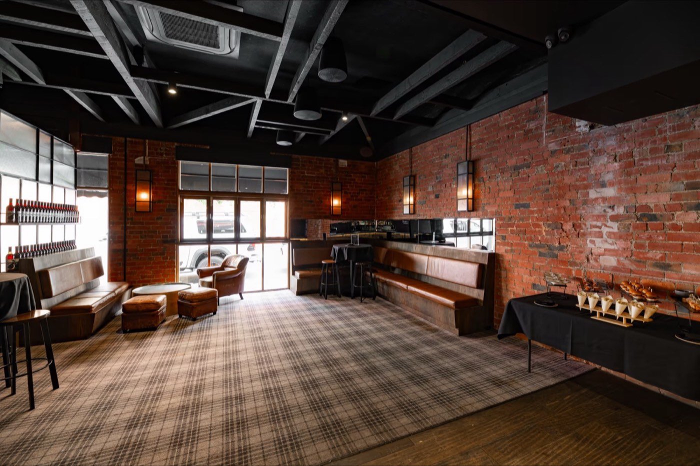 Brick walls, leather booths and plaid carpet inside Penny Young Bar, Moonee Ponds